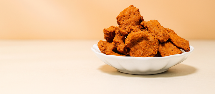 Crispy Nigerian kuli-kuli groundnut snacks served in a white plate – ready-to-eat African snack.