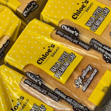 Chloe’s Bread Nigerian Style Agege premium loaf in bright yellow packaging stacked together.
