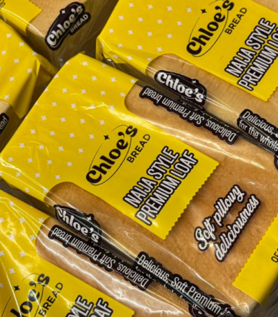 Chloe’s Bread Nigerian Style Agege premium loaf in bright yellow packaging stacked together.